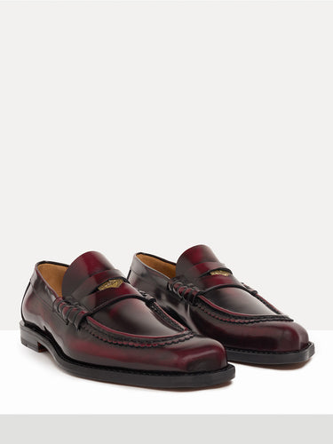 Dark red leather loafer shoes from Vivienne Westwood on a white background