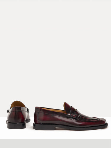 Dark red leather loafer shoes from Vivienne Westwood on a white background