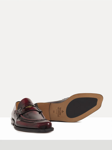 Dark red leather loafer shoes from Vivienne Westwood on a white background
