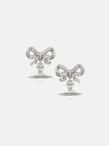 Pair of bow-shaped earrings with clear stones on a white background