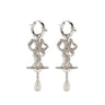 Pair of silver earrings with bow and orb designs and pearl drops from Vivienne Westwood on a white background