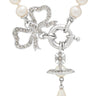 Pearl necklace with a silver bow and orb charm on a white background