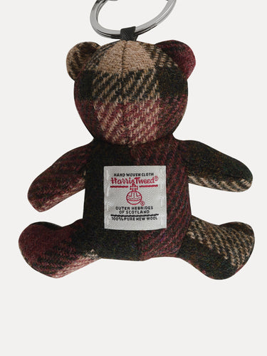 Tweed teddy bear keychain with a label on a white background