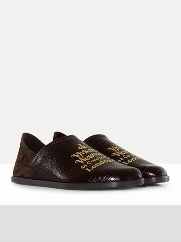 Pair of dark brown loafers with gold text on a white background