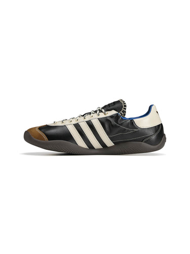 Wales Bonner x Adidas Karintha OG in Core Black Wonder White Lush Blue black leather sneaker with three-stripe detail and tan panel, diagonal side view – Wales Bonner x Adidas SS26