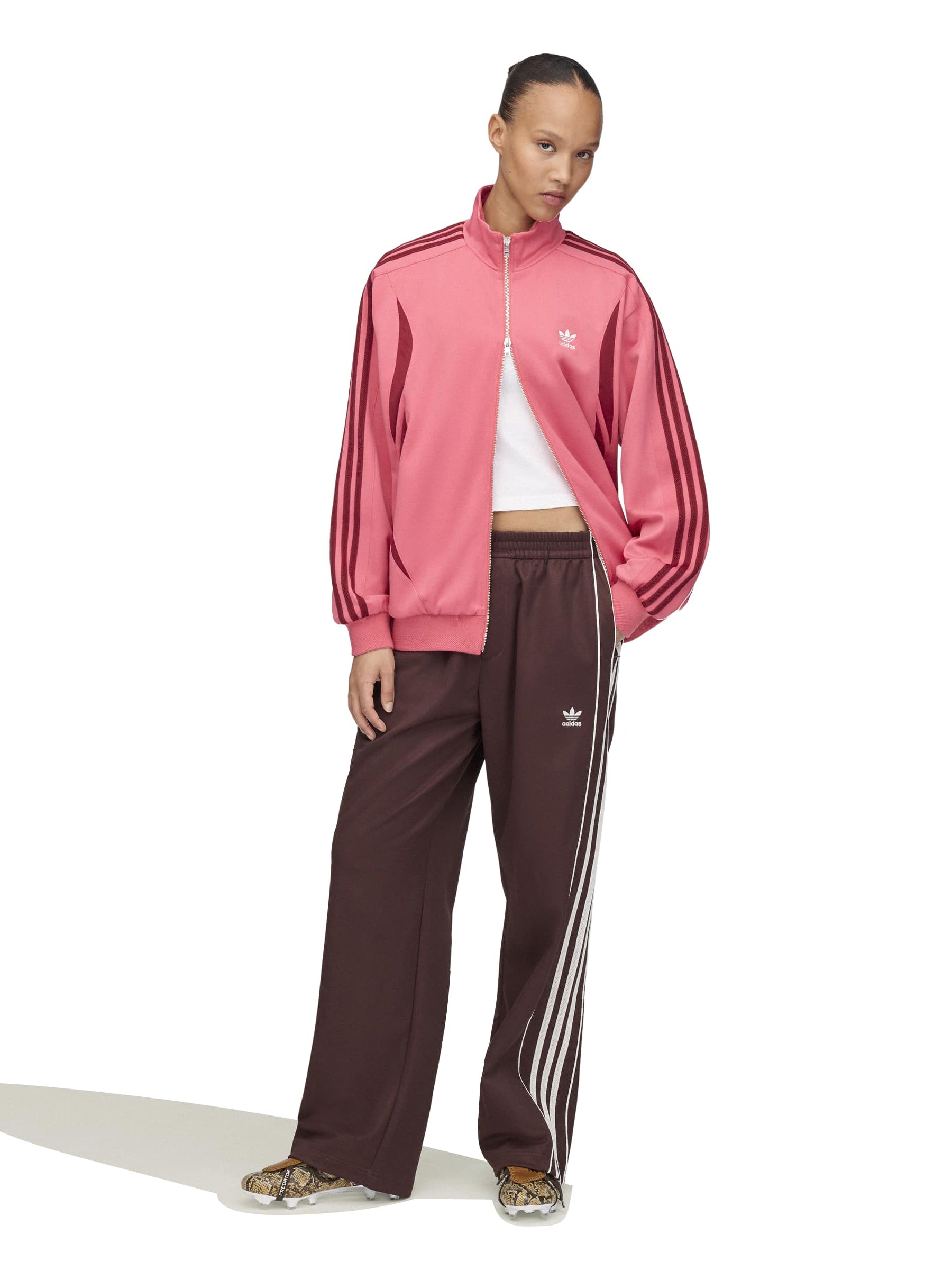 Model wearing the Wales Bonner x Adidas Track Top in Craft Pink pink track jacket with burgundy three-stripe detail and zip closure, full length front view – Wales Bonner x Adidas SS26