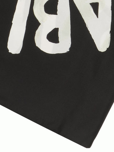 Close-up of black scarf with sunflower illustration from Walter Van Beirendonck