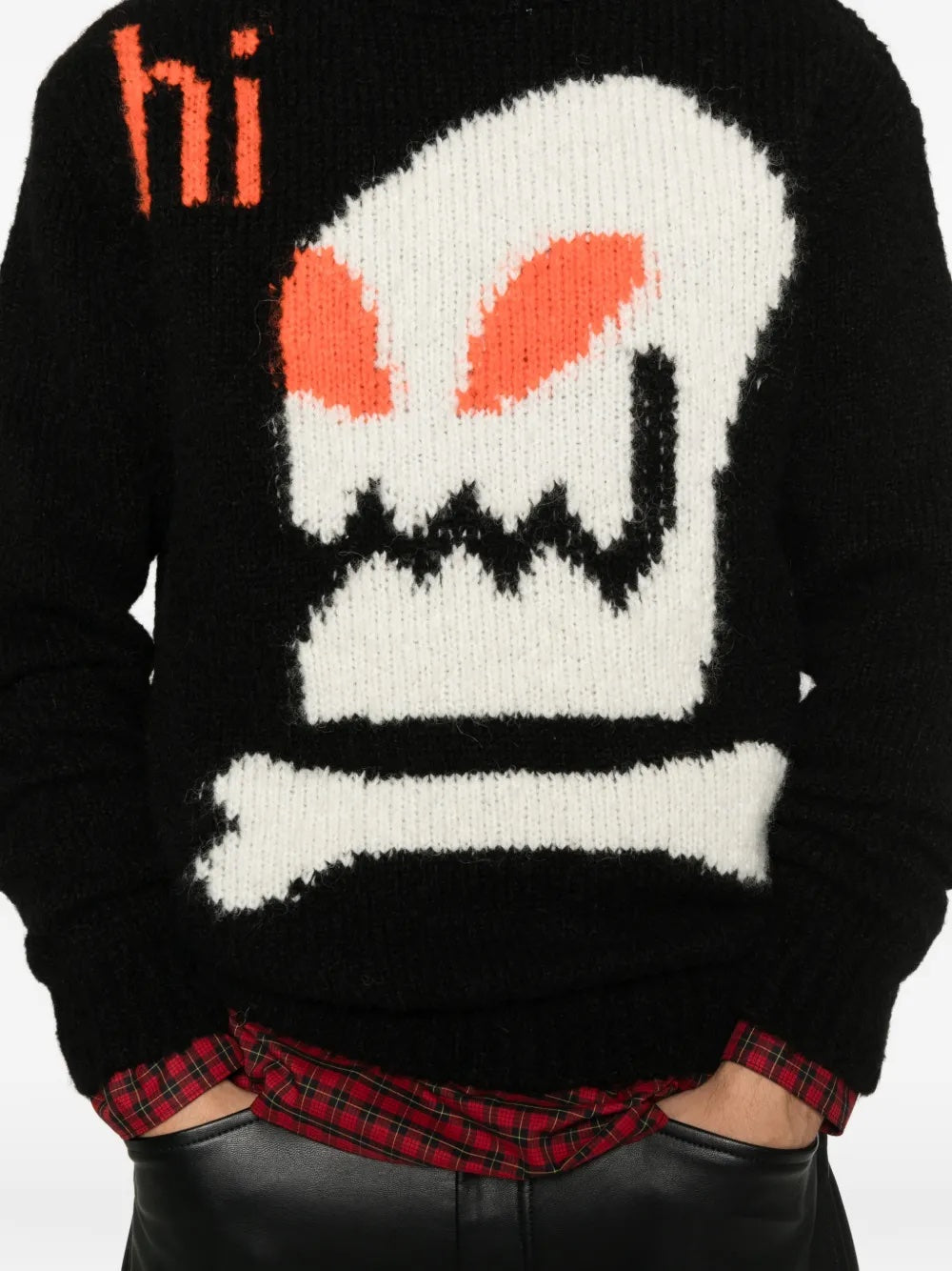 Close-up of the black knitted sweater with skull illustration from Walter Van Beirendonck on a white background.