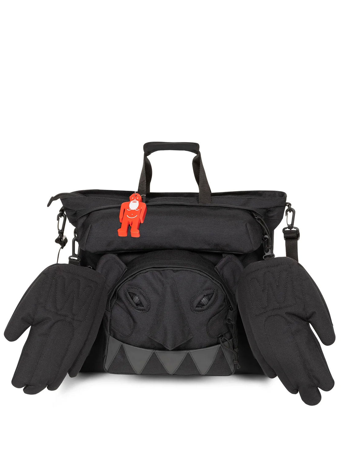 Walter Van Beirendonck x Eastpak Walter Carry Bag in Black, front view with detachable Monster face pouch, hand-shaped side pouches and red Walterman charm