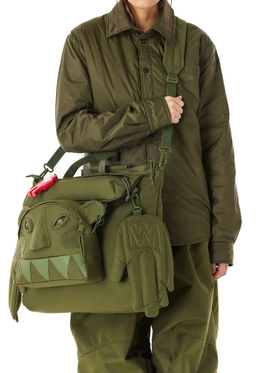 Walter Van Beirendonck x Eastpak Walter Carry Bag worn crossbody, showing detachable Monster face pouch and sculptural hand-shaped side pockets