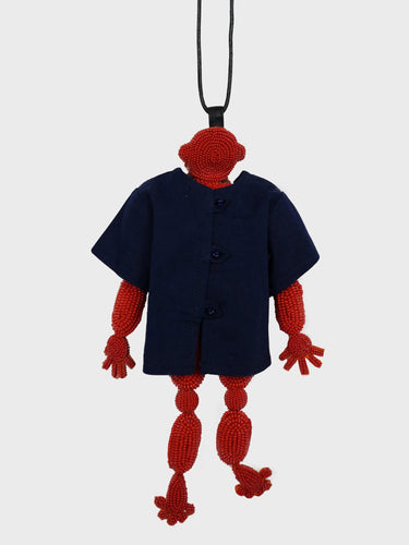 Back view of the Walter Doll T Jewel necklace, showing the reverse side of the red beaded figure and the cotton cord.