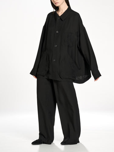 Side view of a female model wearing the Y-3 Chore Jacket Shirt in Black, emphasizing the relaxed drape and lightweight woven fabric.