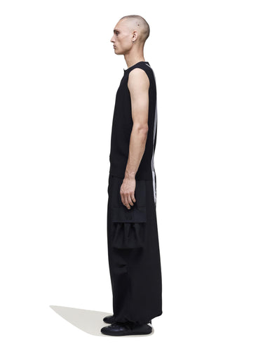 Side view of a male model wearing the Y-3 GFX Knitted Vest in Black, emphasizing the drape and relaxed silhouette.
