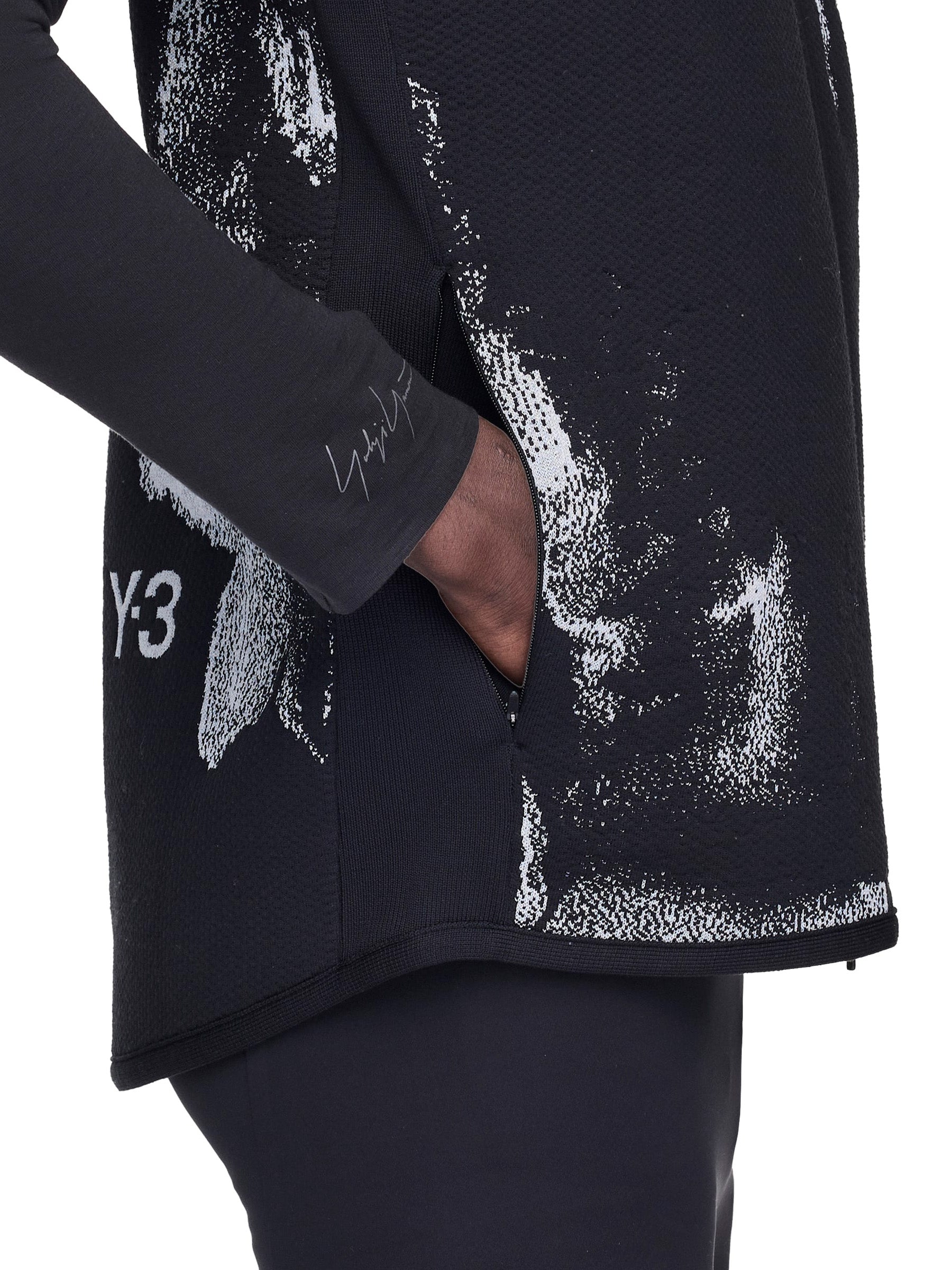 Black vest with white abstract design and Y-3 logo on a white background