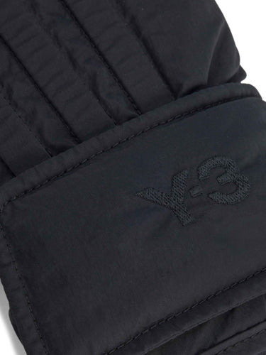Black quilted glove with Y-3 logo on a white background