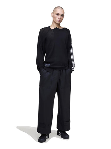 Front view of a male model wearing the Y-3 Logo Knit Sweatshirt in Black, showing the loose, relaxed fit and long sleeves.