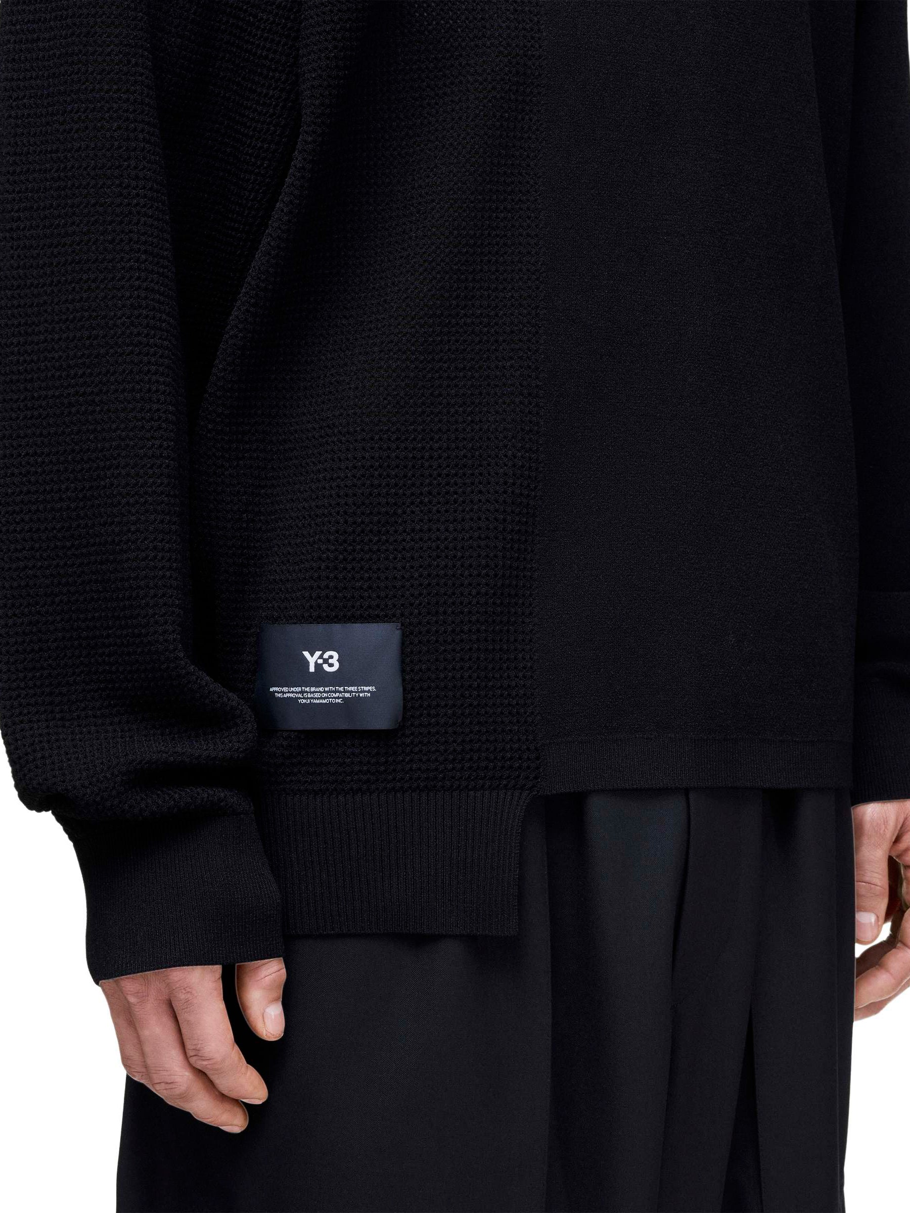 Front view of a female model wearing the Y-3 Logo Knit Sweatshirt in Black, showing the loose fit, long sleeves, and Y-3 logo detail.