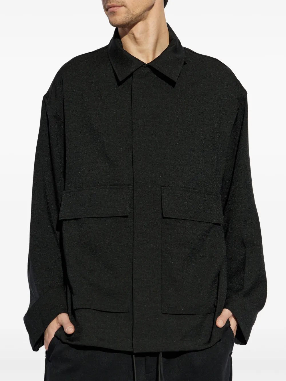 Person wearing a black jacket with a white background