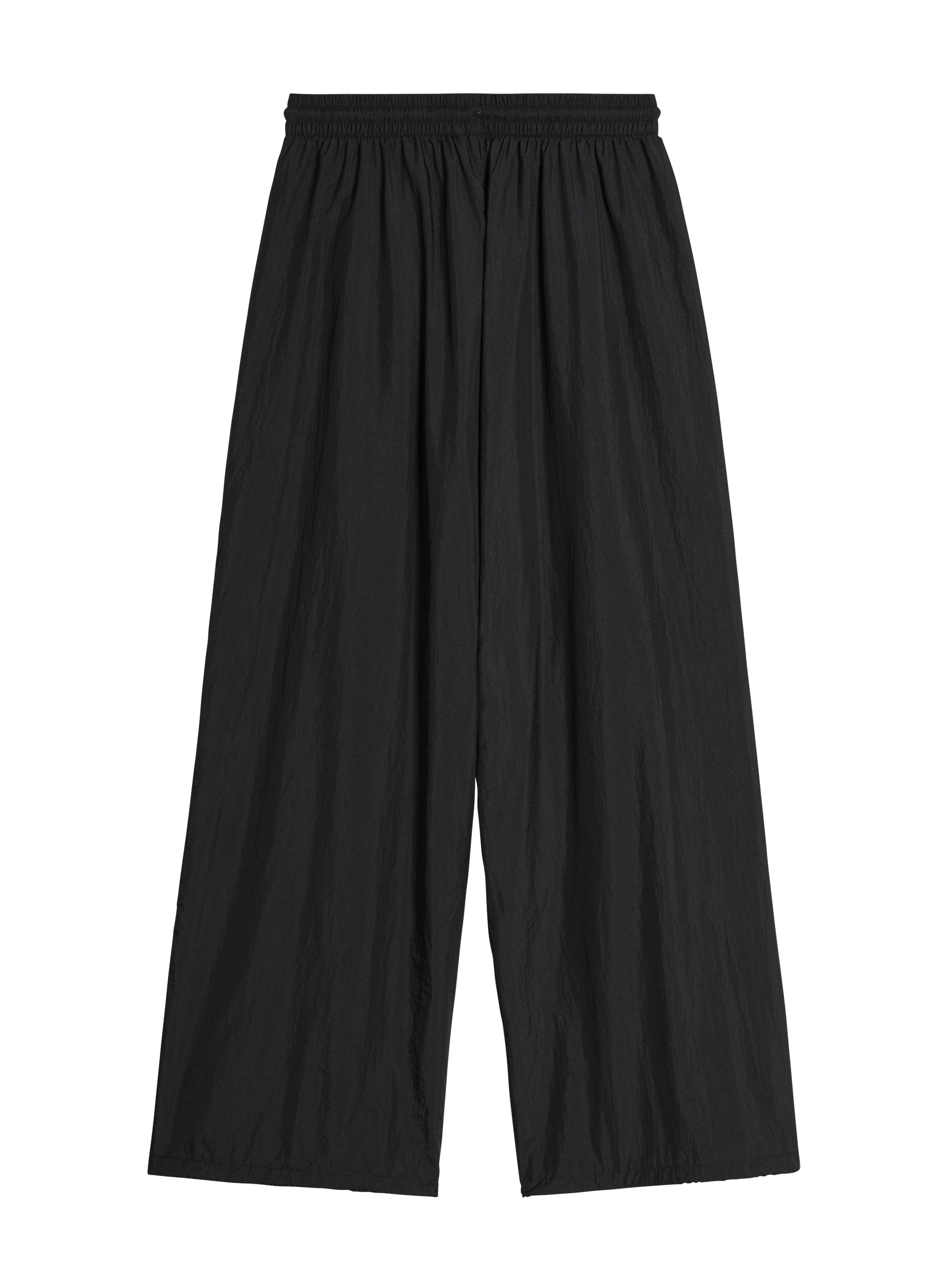 Back packshot of the Y-3 Raw Edge 3-Stripes Wide Tracksuit Bottoms in Black, highlighting the relaxed, wide-leg fit, raw-cut detailing on the right leg, and clean woven construction.