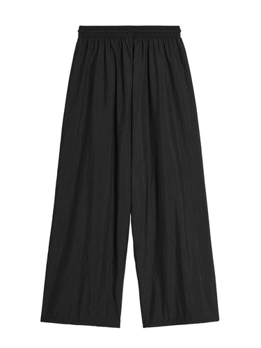 Back packshot of the Y-3 Raw Edge 3-Stripes Wide Tracksuit Bottoms in Black, highlighting the relaxed, wide-leg fit, raw-cut detailing on the right leg, and clean woven construction.