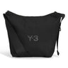 Front packshot of the Y-3 Small Crossbody Bag in Black, showing the durable CORDURA® fabric, front zip pocket, and metallic buckle closure.