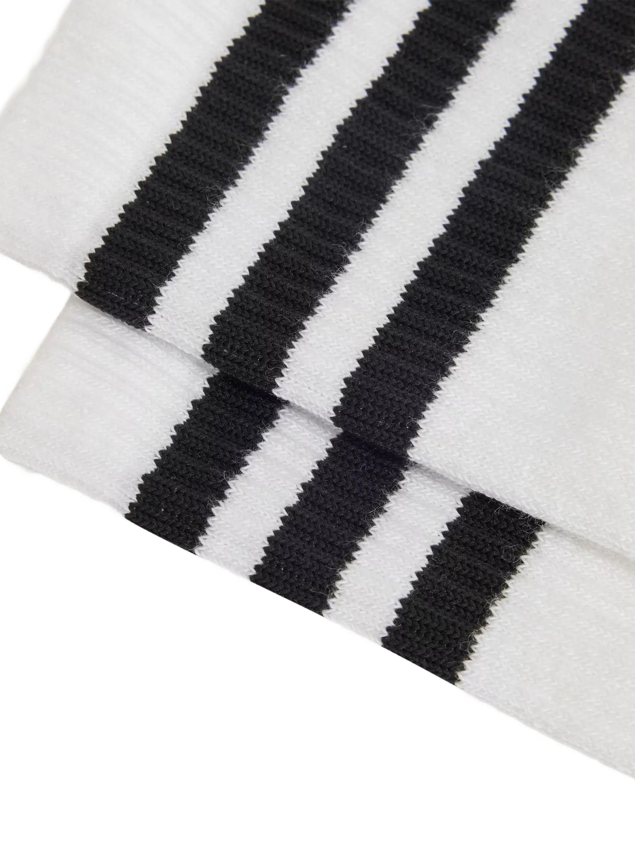 Close-up packshot of the Y-3 Stripes High Socks in White, highlighting the embroidered Y-3 logo, engineered 3-Stripes cuff, and knit texture.