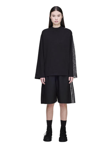 Female model wearing the Y-3 Summer Run 3-Stripes Shorts in black from the front, highlighting the raw-cut 3-Stripes and contemporary silhouette.