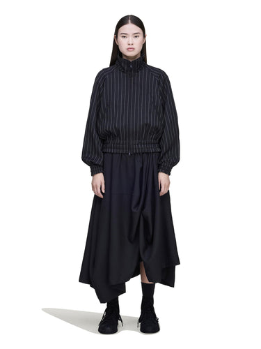 Front view of a female model wearing the Y-3 Summer Utility Skirt in Black, showing the asymmetric cut and draped silhouette.