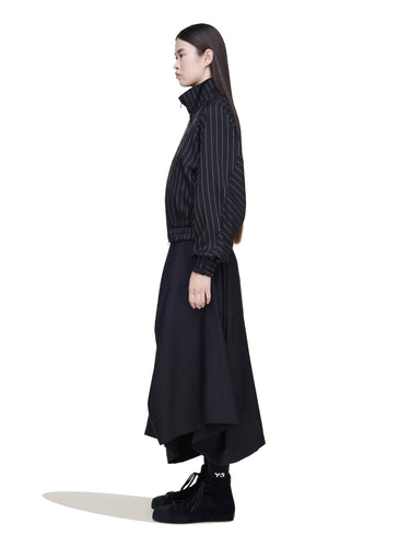 Side view of a female model wearing the Y-3 Summer Utility Skirt in Black, emphasizing the loose, breathable design and flow of the skirt.