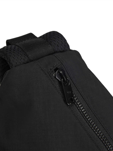 Close-up of the zipper and nylon ripstop texture on the Y-3 Utility Slingbag in Black.