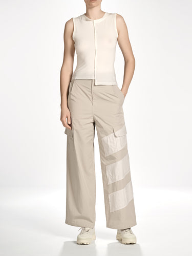 Front view of a female model wearing the Women’s Knit Double-Dye Tank in Beige from Y-3, highlighting the asymmetric neckline, dip-dye effect, and fitted silhouette.