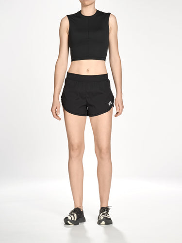 Front view of a female model wearing the Y-3 Women’s Knit Double-Dye Tank in Beige, highlighting the asymmetric, parted crew neckline and fitted silhouette.