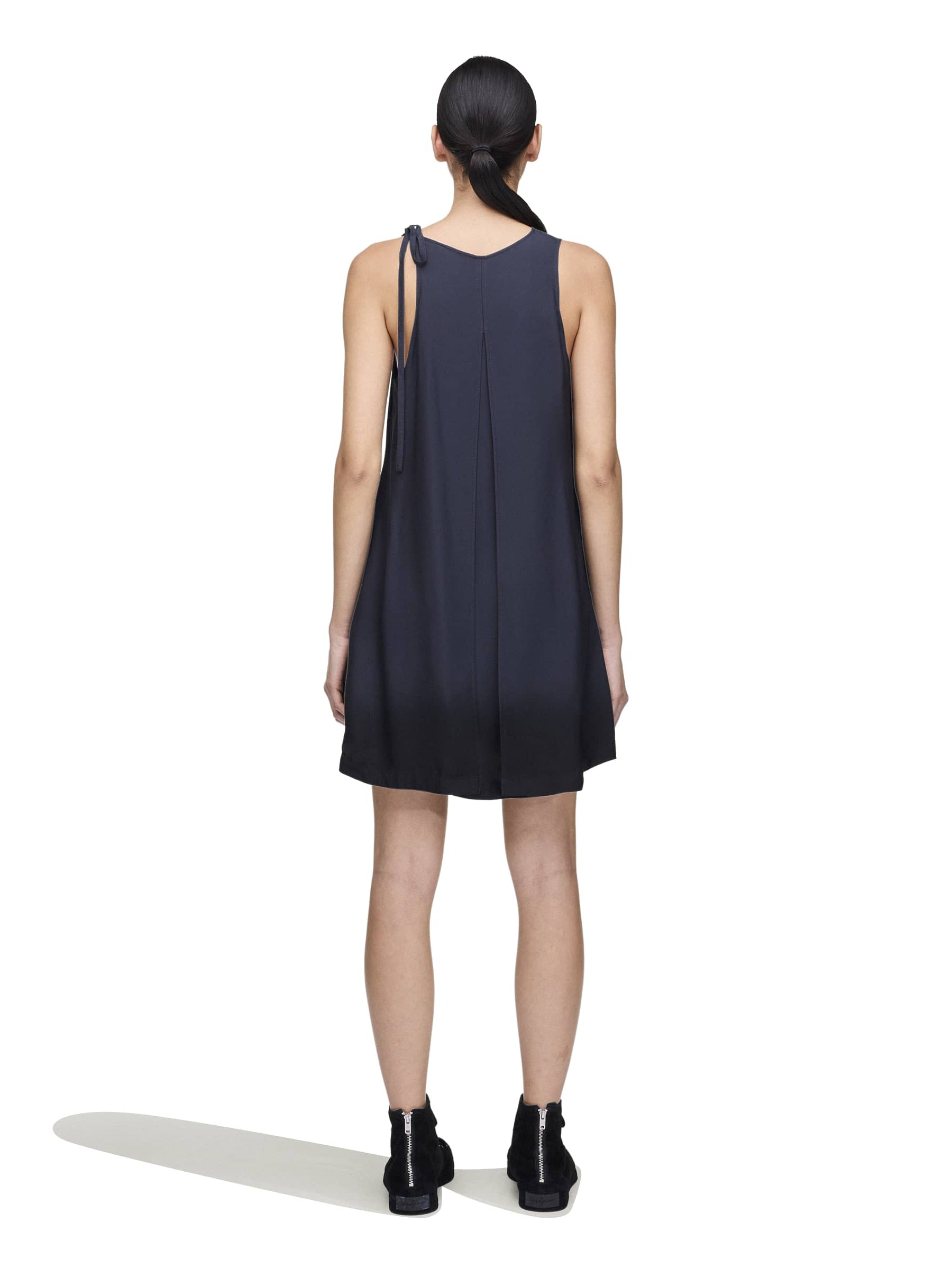 Back view of a female model wearing the Women’s Shirt Double-Dye Dress in night grey and black from Y-3, showing the dip-dye finish and breathable plain-weave fabric.