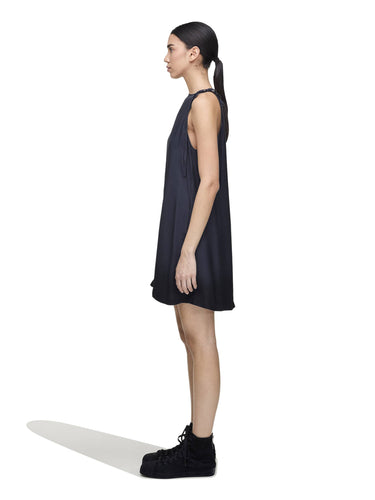 Side view of a female model wearing the Women’s Shirt Double-Dye Dress in night grey and black from Y-3, highlighting the relaxed fit and fluid drape.