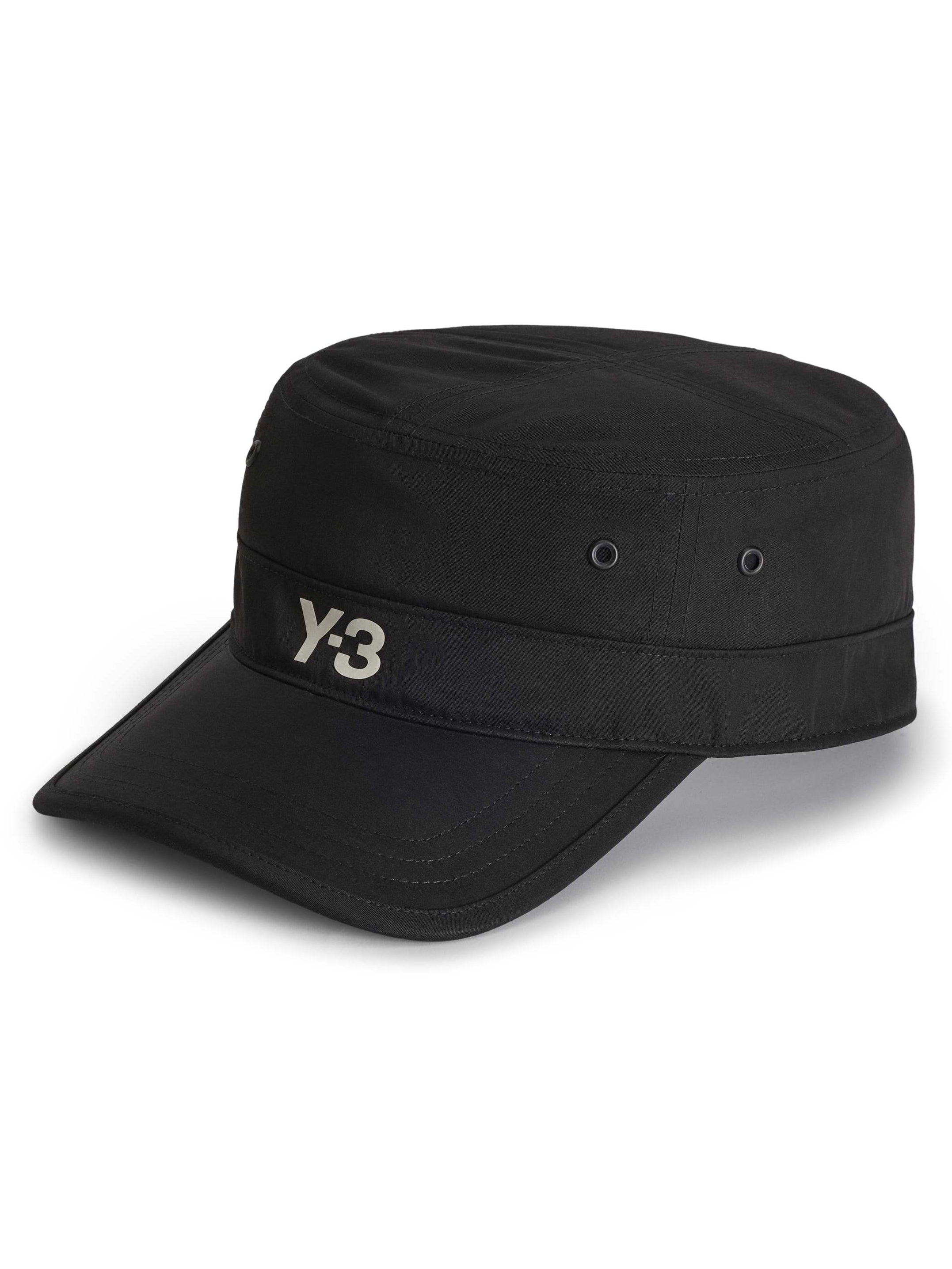 Side-front packshot of the Y-3 Workwear Cap in Black, showing the curved brim, structured fit, and silicone Y-3 logo at the centre front.